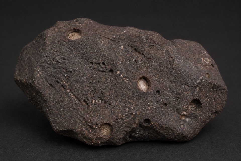 Original generated example image of dark basalt with rounded mineral-filled cavities
